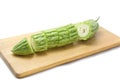 Bitter melon or bitter gourd sliced Ã¢â¬â¹Ã¢â¬â¹on wooden cutting boards on white background. Royalty Free Stock Photo